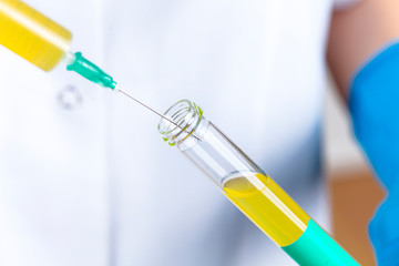 Young female doctor doing a blood test in a laboratory. drug and medical vaccine finding studies. health concept.