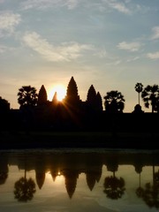Fototapeta na wymiar Angkor Wat during sunrise right behind ruins, shadow Silhouette before lake with reflections, ruins of Angkor, Cambodia