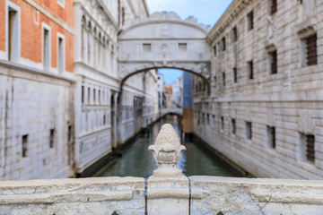 Fototapeta na wymiar Carved pine cone on Ponte della Paglia with a view of Bridge of Sighs and the Doge's, Palace in Venice Italy at sunrise