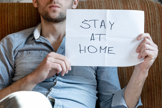 Man Shows The “stay At Home” Sign, Home Isolation During Quarantine Coronovirus Covid -19