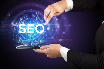 Close-up of a touchscreen with SEO abbreviation, modern technology concept