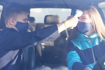  People gets body temperature measured with an infrared non-contact thermometer. Non-contact...
