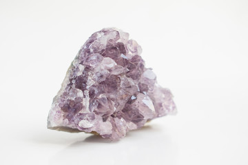 Large amethyst crystal close up photo. Natural stone isolated on light background.