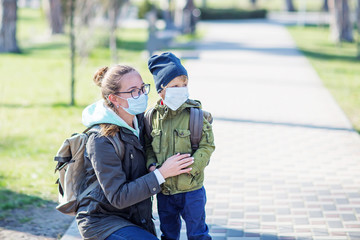 Mother and her son outdoor wearing masks