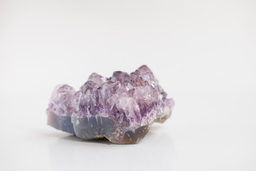 Large amethyst crystal close up photo. Natural stone isolated on light background.