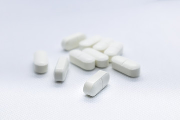 White long health drug pills on white background