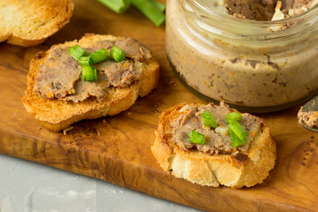 Homemade sandwiches with homemade chicken liver pate  on a cutting board.