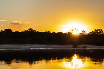 The lush sunset of autumn afternoons in the Brazilian savannah at Praia do Sol, on the banks of the...