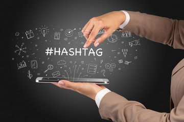 Close-up of a touchscreen with #HASHTAG inscription, social media concept