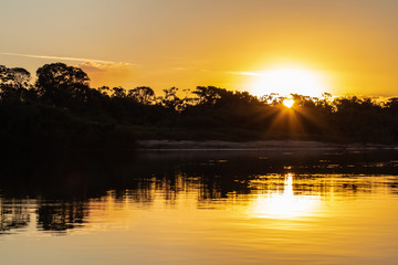The lush sunset of autumn afternoons in the Brazilian savannah at Praia do Sol, on the banks of the...