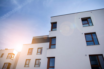 Modern apartment building flat estate concept. Outdoor residential facility at sunset and sunrise.