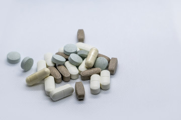 Colored health drug pills on white background