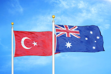 Turkey and Australia two flags on flagpoles and blue cloudy sky © Aleks Taurus