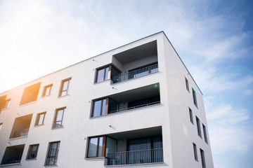 Obraz premium Modern apartment building flat estate concept. Outdoor residential facility at sunset and sunrise.