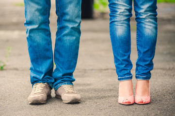 Legs of a guy and a girl in blue jeans