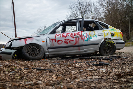 Act of vandalism, destroyed and spray painted car. 