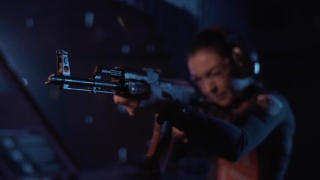 girl shoots from a machine gun