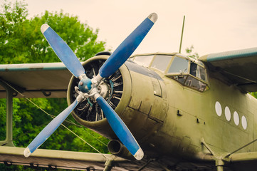 Old green plane in the parking lot