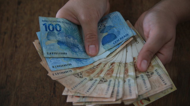 hands hold real cedulas