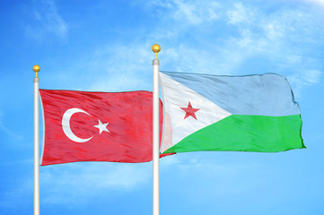 Turkey and Djibouti two flags on flagpoles and blue cloudy sky