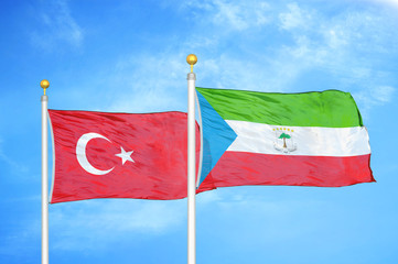 Turkey and Equatorial Guinea two flags on flagpoles and blue cloudy sky