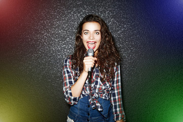 Woman singing with microphone - fashion pstudio portrait
