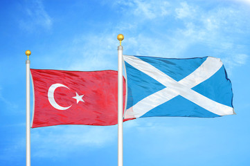 Turkey and Scotland two flags on flagpoles and blue cloudy sky