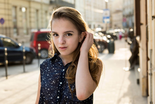 Portrait of teenage girl. Girl with a birthmark over her lip. Spring sunny concept. 8 March. Happy Women's Day. Beautiful girl walking in the city.