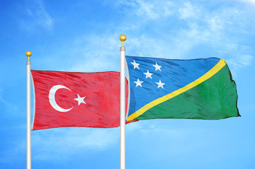 Turkey and Solomon Islands two flags on flagpoles and blue cloudy sky