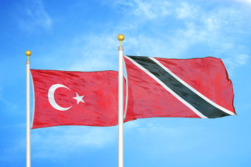 Turkey and Trinidad and Tobago two flags on flagpoles and blue cloudy sky