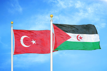 Turkey and Western Sahara two flags on flagpoles and blue cloudy sky