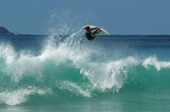 Surfer Launches Big Air On Blue Tropical Wave