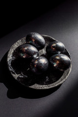 eggs on a black background with gold on a plate Easter still life. One color is minimalism. stylish festive decor handmade. The egg is decorated beautifully modern