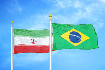 Iran and Brazil  two flags on flagpoles and blue cloudy sky