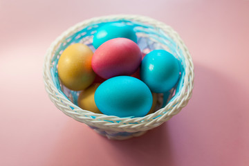 Fototapeta na wymiar Eggs of different colors in an Easter basket. Easter holiday