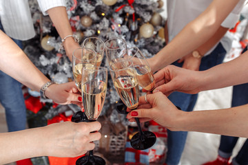 Close up of many hands holding glasses of champagne