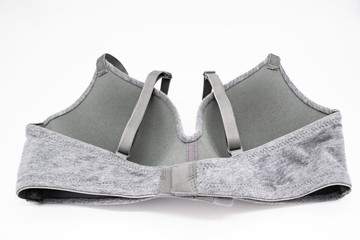 Simple grey bra on a white background. Wrong side, wrong side of underwear , hook-and-eye closure