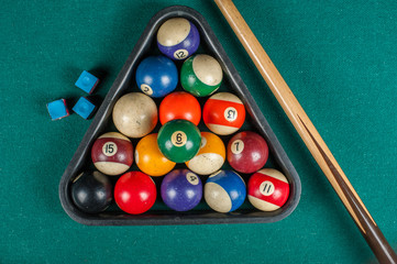 Billiards balls and cue on billiards table. Billiard sport concept