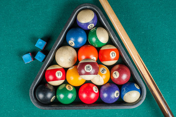 Billiards balls and cue on billiards table. Billiard sport concept