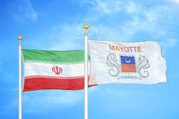 Iran and Mayotte two flags on flagpoles and blue cloudy sky
