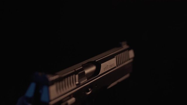 Stock video footage firearm firing of a gun in the dash
