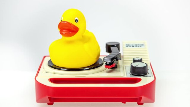 Rubber duck rotating on vintage record player.