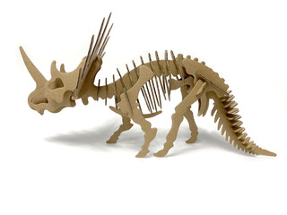 3d cardboard dinosaur puzzle on a white background. children's designer from cardboard. 3D volume puzzle. 3d puzzle toy. children`s constructor on a white background isolated. side view 