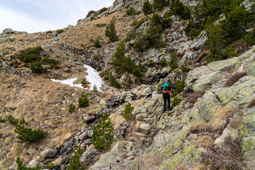 Fototapeta premium Hiker woman with her dog in National Park of Aigüestortes and lake of Sant Maurici.