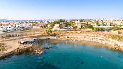 Aerial bird's eye view of Kapparis (fireman's) beach in Protaras, Paralimni, Famagusta, Cyprus. Tourist attraction golden sand Kaparis bay with boats, sunbeds, sea restaurants, water sports from above