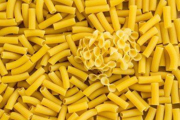 Some bow tie shape macaroni on hort Cut Pasta Background,top view.