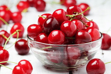 A small glass bowl with ripe fresh cherry	