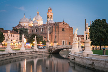 Fototapeta na wymiar View of Basilica Santa Giustina and canal with statues on square Prato della Valle in Padova (Padua), Veneto, Italy