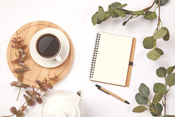 Cup coffee, pencil, branch with leaf, paper note on white background.