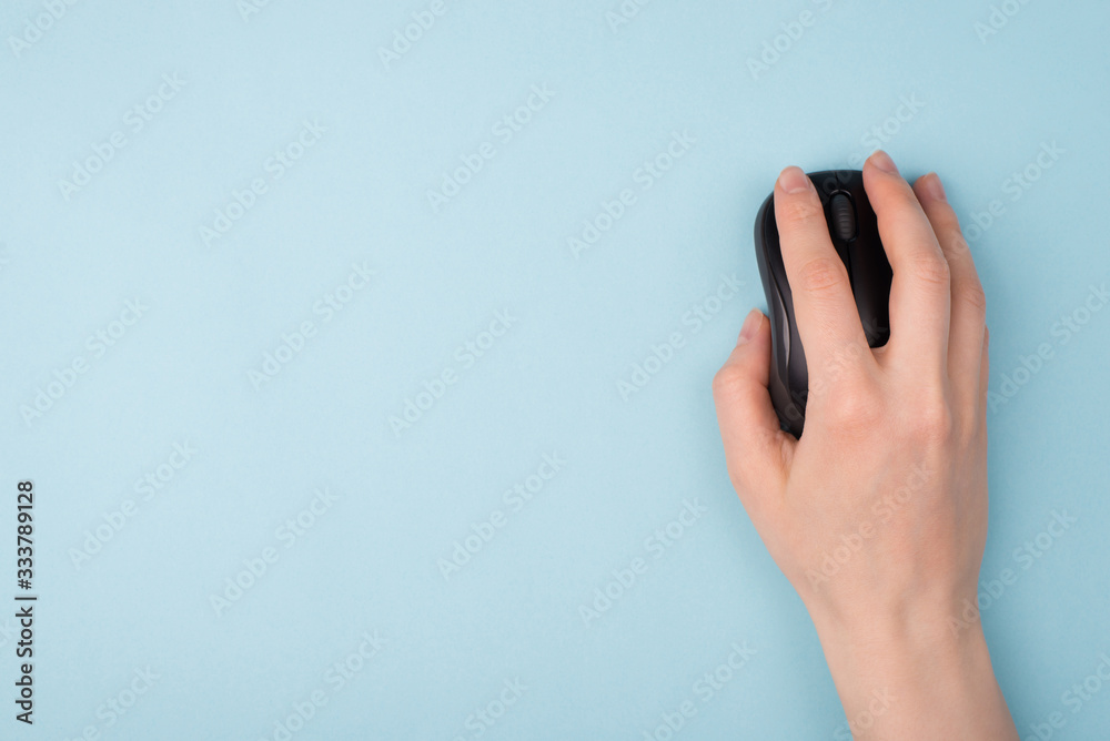 Wall mural top above close up view photo of hand using wireless computer mouse for searching necessary informat